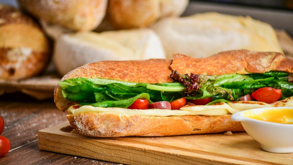 baked bread with vegetable on brown chopping board