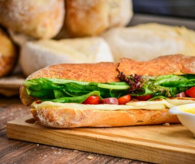 baked bread with vegetable on brown chopping board